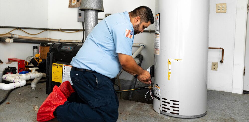 Arnold & Sons Technician performing a water heater repair