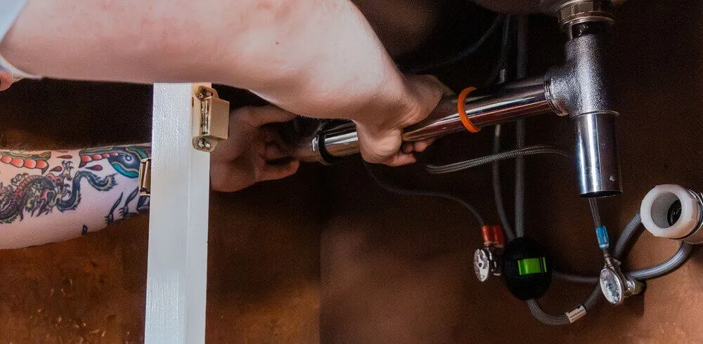 Arnold & Sons Technician performing a drain repair