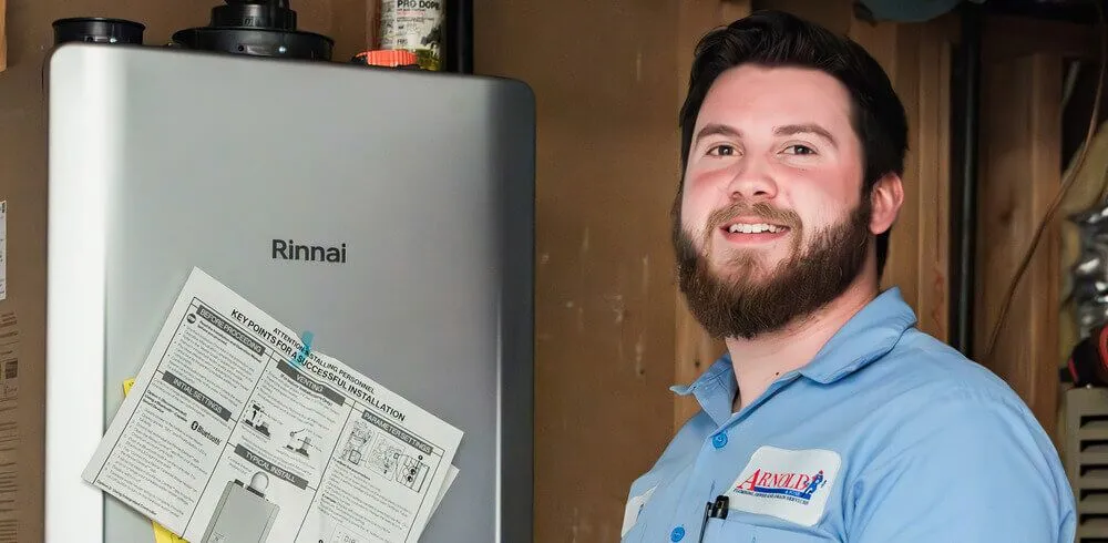 Arnold & Sons Technician repairing a tankless water heater