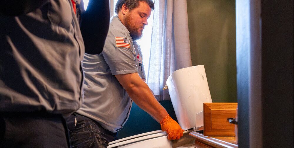 Arnold & Sons Technician installing a toilet