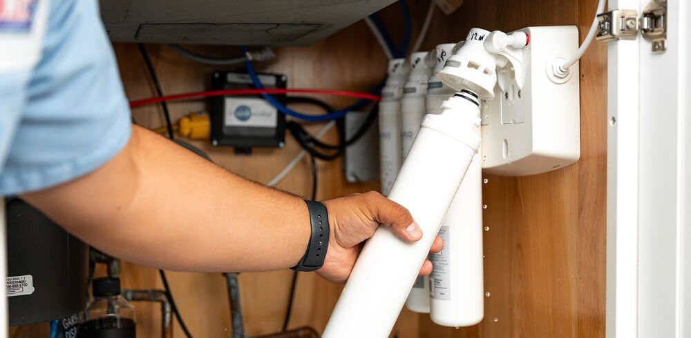 Arnold & Sons Technician performing a water filtration installation