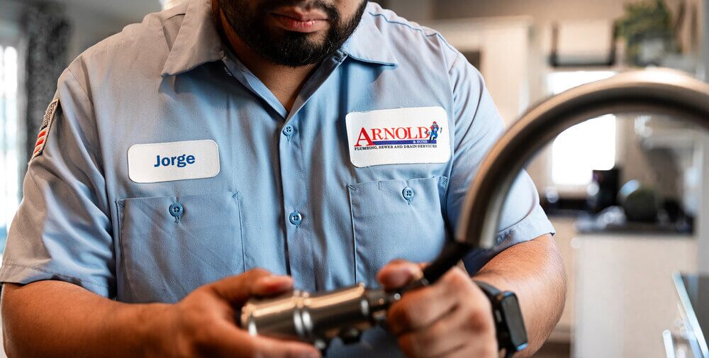 Arnold & Sons Technician upgrading a kitchen faucet