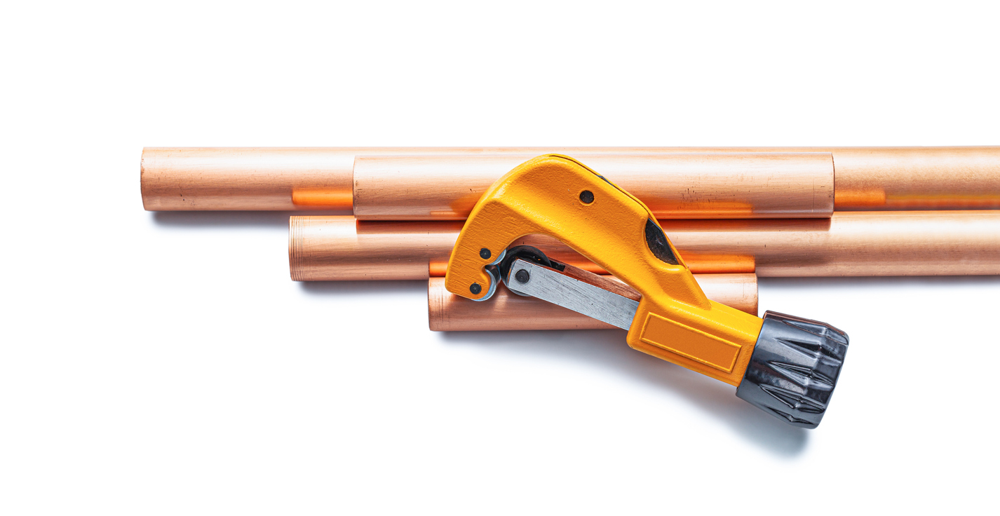 Yellow Pipecutter And Copper Pipes Isolated